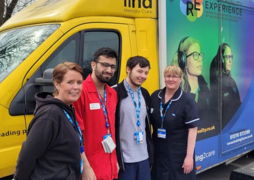 A few colleagues stood outside the Autism Bus