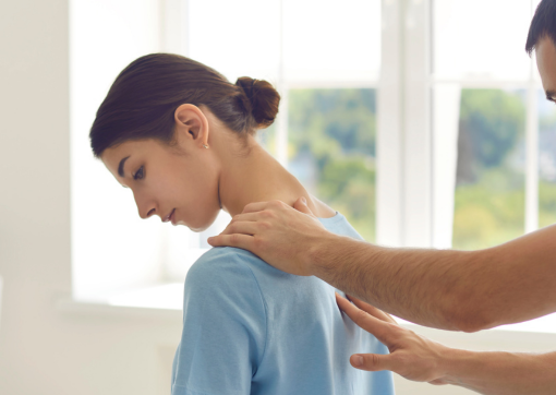 An image of the back of a woman's head receiving physiotherapy treatment 