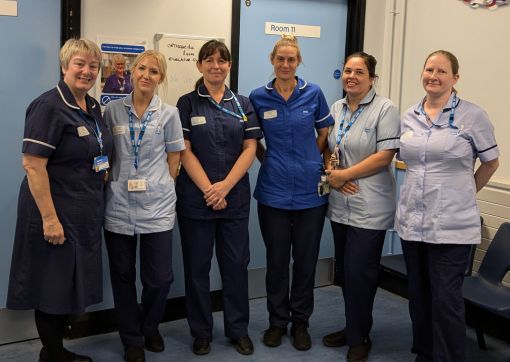 Members of the team involved in the WISE study, stood as a group in a clinic area